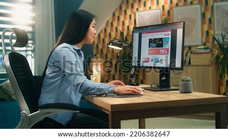 Female asian web designer using personal computer for creating website in professional constructor while working on project remotely at home. Freelance