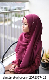 A Female Asian Young Lady Having A Conversation And Not Looking At The Camera