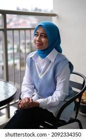 A Female Asian Young Lady Smiling And Not Looking At The Camera