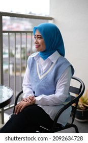 A Female Asian Young Lady Smiling And Not Looking At The Camera