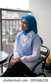 A Female Asian Young Lady Smiling And Not Looking At The Camera