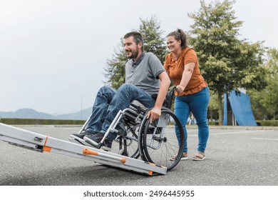 Female assistant helping a male person in wheelchair with transport using accessible vehicle van ramp. Disability and mobility concepts. - Powered by Shutterstock