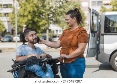 Female assistant helping a man in a wheelchair to use a smartphone. Disability and daily activity concepts. - Powered by Shutterstock