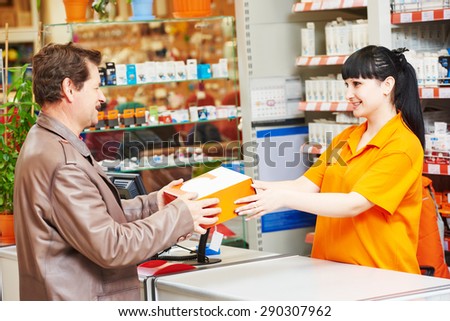 female assistant seller selling lamp to purchaser in hardware shopping mall supermarket