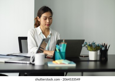 Female assistant typing the importance topics on laptop computer during the business meeting in board room - Shutterstock ID 2064533549