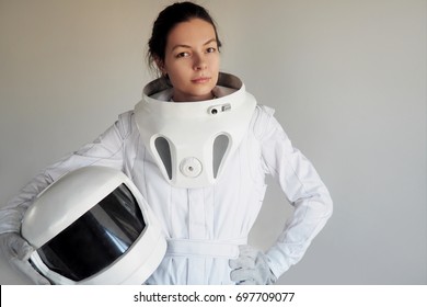 Female astronaut on a white background. Fantastic space suit. Exploration of outer space.