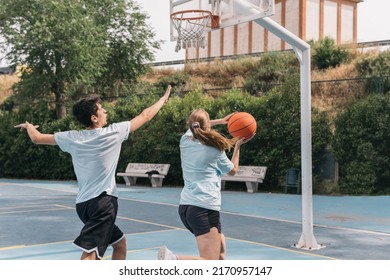 Female Athlete Competing Against Her Partner In Basketball. Blonde Girl Dribbling With Ball To Her Friend. Concept Of Sport.