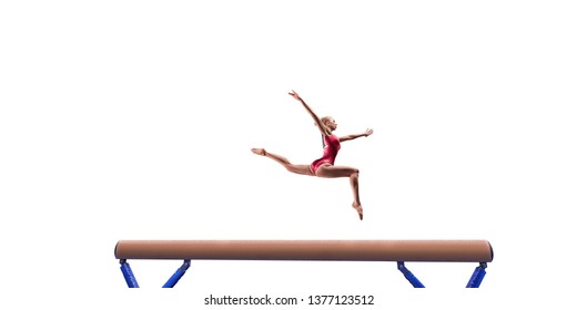 Female athlete doing a complicated exciting trick on gymnastics balance beam on white background. Isolated Girl perform stunt in bright sports clothes
