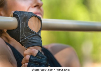 Female Athlete Doing Hard One Arm Pull-ups