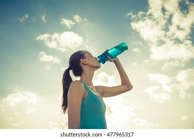 Female athlete drinking water.  - Powered by Shutterstock