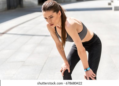 Female athlete is exhausted after jogging - Powered by Shutterstock