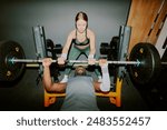 Female athlete helping her shredded African American friend with lifting heavy weight