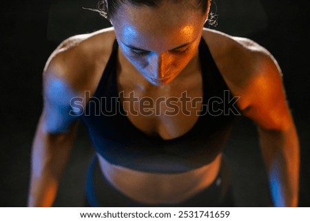 Similar – Rear view portrait of one young middle age athletic woman at crossfit training, exercising with trx suspension fitness straps over dark background