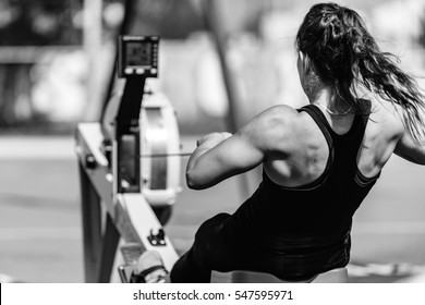 Female athlete on rowing machine on cross competition. - Shutterstock ID 547595971