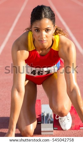 Female athlete on starting blocks