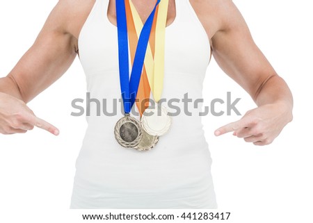 Female athlete pointing her medals on white background