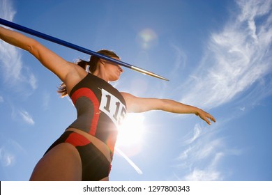 Female athlete preparing to throw javelin in athletics competition - Powered by Shutterstock