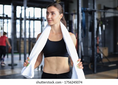 Female Athlete Preparing For A Workout In A Gym.