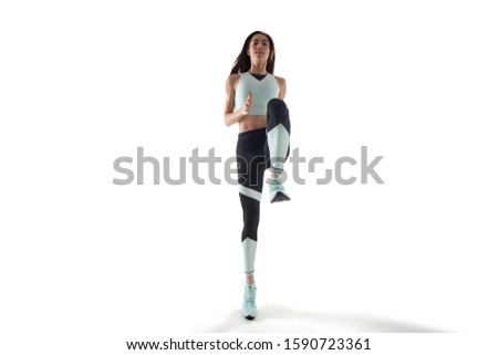 Female athlete running isolated on white.