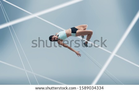 Female athlete running and jumping. Side view shot of healthy woman working out against hi tech background. 
