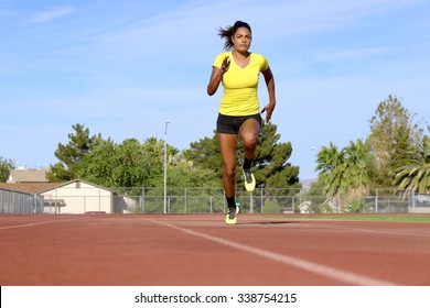 Female Athlete Running On Race Track