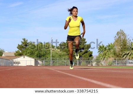Female Athlete Running on Race Track