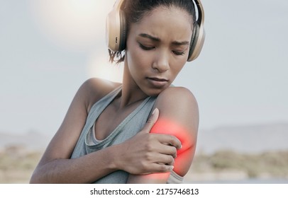 Female Athlete With A Shoulder Pain After An Intense Workout. Young Sports Woman With An Injury Or Hurt Arm Highlighted In Red. An Athletic Female Suffering From Inflammation Or Stiff Muscle