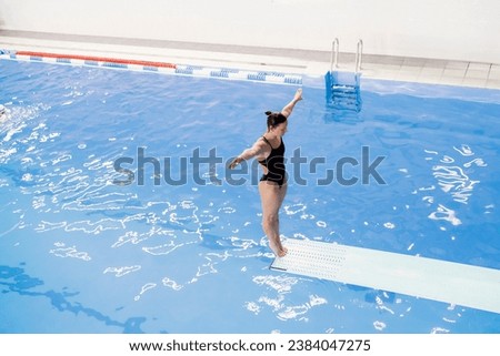 female athlete stands on a springboard, diving competition Stockfoto © 