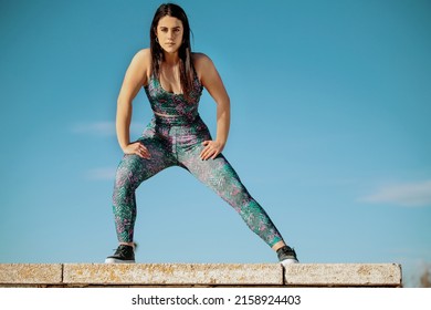 Female Athlete Stretching Against The Sky