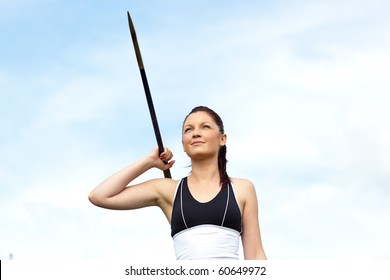 Female athlete throwing the javelin outdoors - Powered by Shutterstock