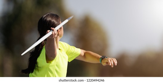 Female athlete throwing a javelin, rear view - Powered by Shutterstock