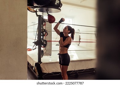 Female Athlete Training With A Small Punching Bag In A Boxing Gym. Female Boxer Working Out In A Fitness Gym.