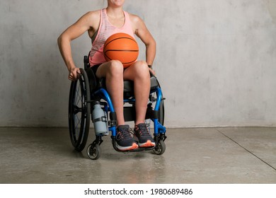 Female Athlete In A Wheelchair With A Basketball