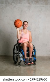 Female Athlete In A Wheelchair Holding A Basketball