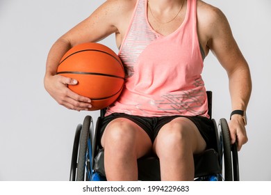 Female Athlete In A Wheelchair Holding A Basketball