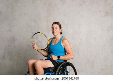 Female Athlete In A Wheelchair Holding A Tennis Racket