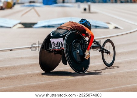 female athlete in wheelchair racing track stadium in para athletics competition, summer sports games