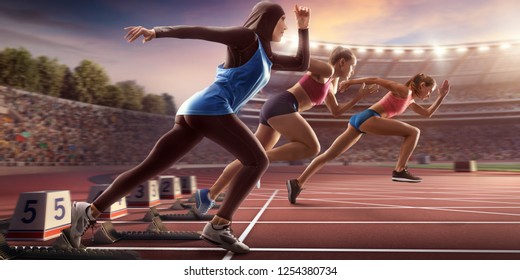 Female Athletes Sprinting. Women In Sport Clothes Run At The Running Track In Professional Stadium. Muslim Athlete Runs In Sports Hijab