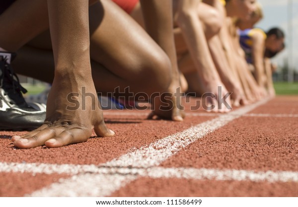 Female athletes at starting\
line
