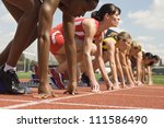 Female athletes at starting line on race track