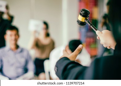 Female auction control Hand point and hammer bid winner highest bidder in final lift,with people and businessman participate in public sale property auctioned business competition,concept bidding - Shutterstock ID 1139707214