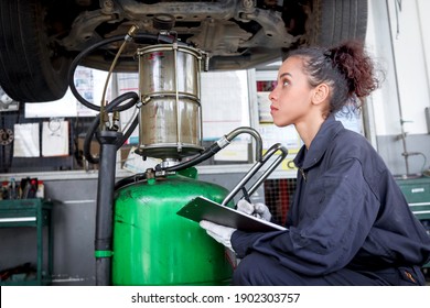 Female Auto Mechanic Work In Garage, Car Service Technician Woman Check And Repair Customer Car At Automobile Service Center, Inspecting Car Under Body And Suspension System, Vehicle Repair  Shop.