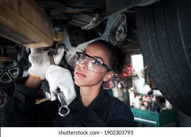 Female Auto Mechanic Work In Garage, Car Service Technician Woman Check And Repair Customer Car At Automobile Service Center, Inspecting Car Under Body And Suspension System, Vehicle Repair  Shop.