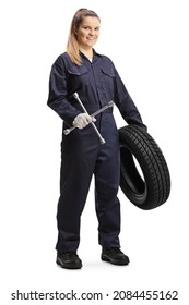 Female Auto Mechanic Worker Holding A Tire And A Lug Wrench Isolated On White Background