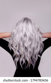 Female Back With Long Curly Blonde Silver Hair On Grey Background