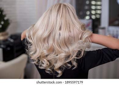 
Female Back With Long Curly Blonde Hair In Hairdressing Salon