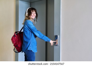 Female With Backpack Standing Near Elevator Door Pressing Call Button