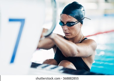 Female Backstroke Swimmer Starting The Race