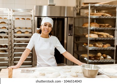 female baker standing at workplace on baking manufacture - Powered by Shutterstock