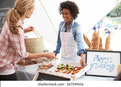 Female Bakery Stall Holder At Farmers Fresh Food Market - Powered by Shutterstock